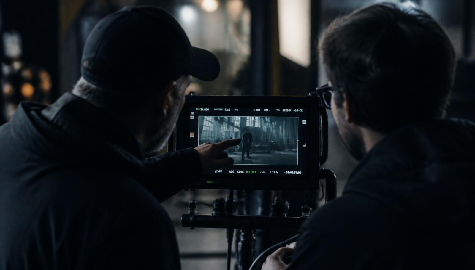 Director and cinematographer reviewing a shot on a field monitor — Video Scriptwriting Services for Pharmaceutical in Mumbai