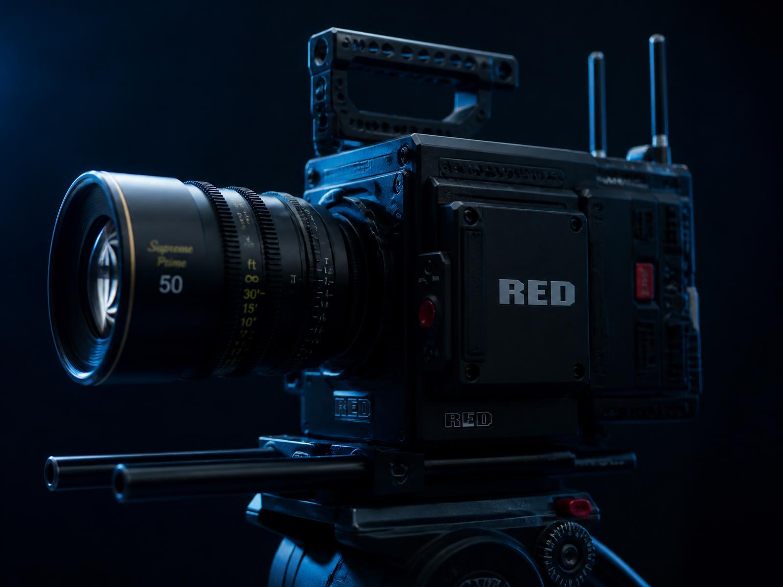 Large-format cinema camera body on a fluid head with a cine prime lens