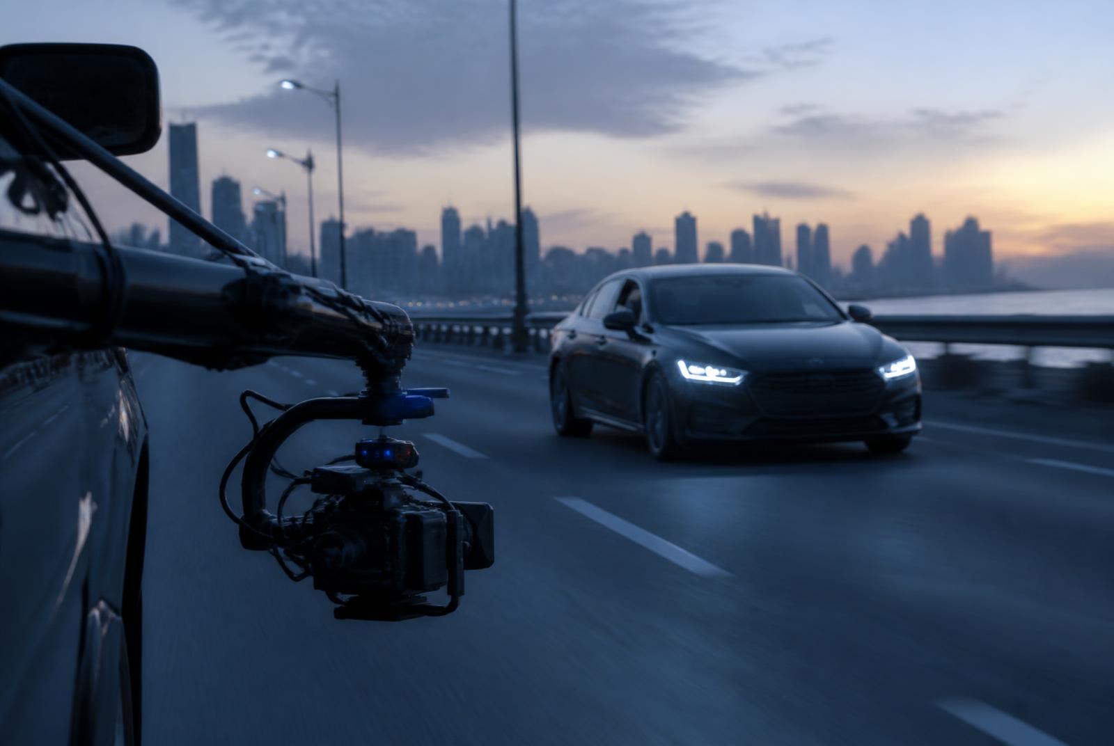 Camera car rig filming a car on a coastal Mumbai road at dawn — Automotive video production in Mumbai